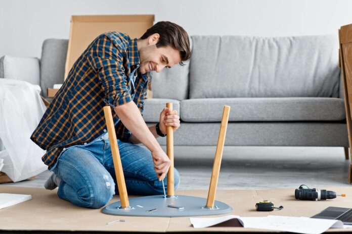 Furniture repair and assembly, handyman fixing table using tool, assembling at home after renovation
